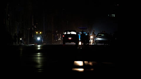 People walk along a street during a blackout in Havana, Cuba, Monday, July 6, 2026.