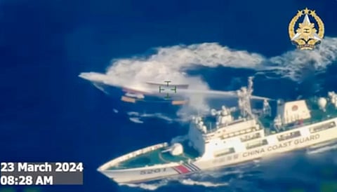 In this image made from video provided by the Armed Forces of the Philippines, a Chinese coast guard ship uses water cannon on a Philippine resupply vessel Unaizah May 4 as it approaches Second Thomas Shoal, locally called Ayungin shoal, at the disputed South China Sea on March 23, 2024