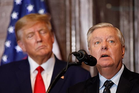 US President Donald Trump looks on as US Senator Lindsey Graham (R-SC) addresses the crowd during a 2024 election campaign event in Columbia, South Carolina, on January 28, 2023.
