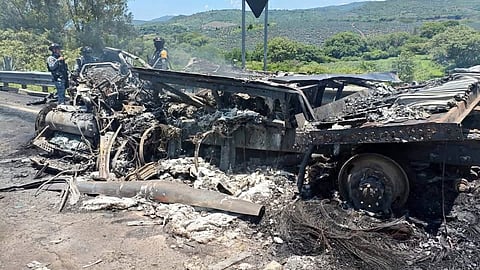 This handout photo released by the Security and Civil Protection Secretariat of Nayarit state shows the charred remains of a vehicle following a road accident on the Guadalajara-Tepic highway in Jalisco state, Mexico, on July 12, 2026.