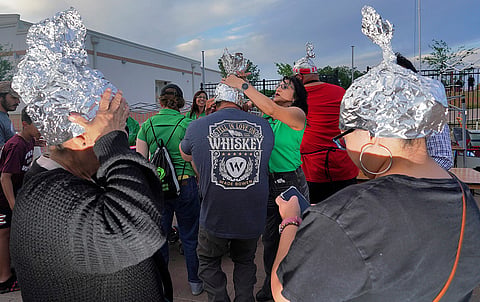 Attendees at the Edinburg UFO festival donning tin foil hats in Edinburg, Texas in 