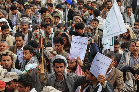Houthis shout slogans during a celebration to commemorate the 7th-century martyrdom of Imam Hussein, one of Prophet Muhammad's grandsons and one of Shiite Islam's most beloved saints, in Sanaa, Yemen, Thursday, June 25, 2026. Arabic reads, " lessons from Ashoura."