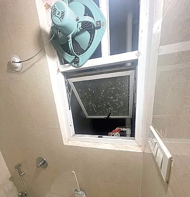The bathroom window through which the teenager tried to exit 