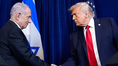 Israel Prime Minister Benjamin Netanyahu (L) shakes hands with President Donald Trump.
