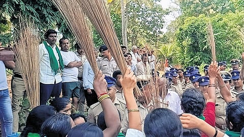 Farmers protest with brooms against the government’s decision to acquire land for the proposed Greater Bengaluru Integrated Township project in Bidadi, on Monday