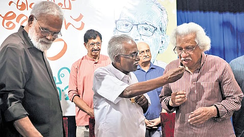 Film critic MF Thomas sharing a piece of cake with filmmaker Adoor Gopalakrishnan during his 80th birthday celebration in Thiruvananthapuram. Senior journalist John Mundakayam, filmmaker T V Chandran, and critic V Rajakrishnan are also seen.
