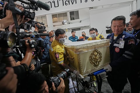 A coffin of a victim in a music bar fire is prepared to be handed over to the relatives, unseen, at a police hospital in Bangkok, Thailand, Tuesday, July 14, 2026.