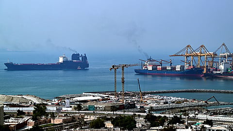 Ships are docked along a pier at the Khor Fakkan Container Terminal, the only natural deep-sea port in the region and one of the major container ports in the Sharjah Emirate, along the Gulf of Oman, on July 14, 2026.