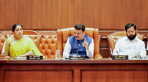 In this photo from June 29, 2026, Maharashtra Chief Minister Devendra Fadnavis (C) speaks during a review meeting in Mumbai. Deputy Chief Ministers Sunetra Ajit Pawar (L) and Eknath Shinde (R) are also present.