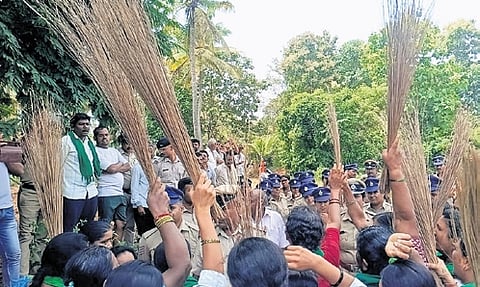 A file photo of farmers protesting with brooms against the proposed township project in Bidadi on Monday