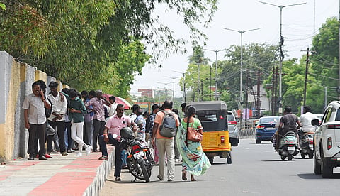 People take refuge in the shade of a tree on Dindigul Road on Wednesday to escape from the scorching July heat.