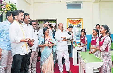Chief Minister A Revanth Reddy interacts with students after inaugurating the girls high school building at Kothakota in Wanaparthy