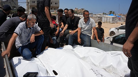 Palestinians carry the bodies of people killed in an Israeli military strike on a residential building on the back of a vehicle as they attend their funeral at Al-Aqsa Hospital in Deir al-Balah, central Gaza Strip, Wednesday, July 15, 2026.