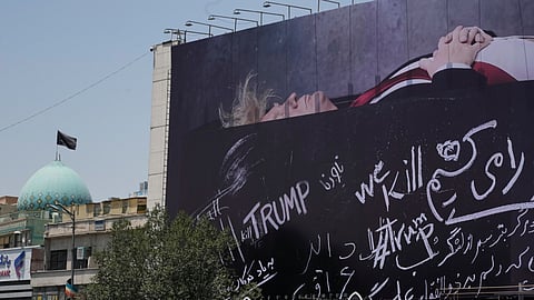 A billboard depicting U.S. President Donald Trump lying on what appears to be a coffin and bearing anti-Trump messages, including the phrase "We Kill Trump," is seen at Islamic Revolution Square in downtown Tehran, Iran, Wednesday, July 15, 2026.