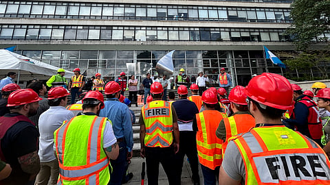Municipal brigade members remain outside the Guatemala City municipal building following an evacuation in Guatemala City on July 17, 2026, after a 7.3-magnitude earthquake struck southern Mexico and parts of Central America.