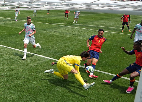 Belgium's Senne Lammens (yellow) mistake proved costly against Spain