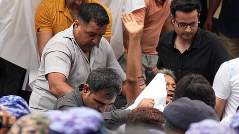 Activist Sonam Wangchuk, who has been on an indefinite hunger strike for 21 days, waves as he is shifted to a hospital from Jantar Mantar, in New Delhi, Saturday, July 18, 2026. 