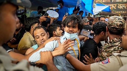  Security personnel detain supporters of the Cockroach Janata Party (CJP) as they raise slogans after activist Sonam Wangchuk, unseen, who has been on an indefinite hunger strike for 21 days, is shifted to a hospital from Jantar Mantar, in New Delhi, Saturday, July 18, 2026. 