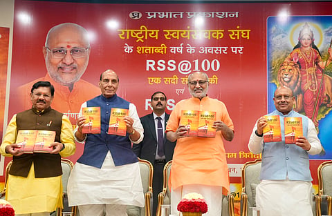 Vice President CP Radhakrishnan along with Union Defence Minister Rajnath Singh releasing the book RSS @100: A Century of Service, Unity & Sacrifice, authored by Shyam Jaju and Anupam Trivedi, at Uprashtrapati Bhavan in New Delhi