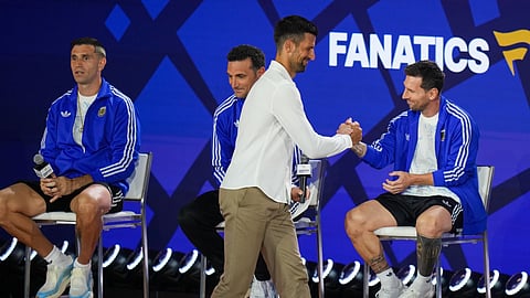 Tennis player Novak Djokovic greets Argentina's Lionel Messi as goalkeeper Emiliano Martinez, left, and head coach Lionel Scaloni look on during a news conference ahead of the World Cup final soccer match between Spain and Argentina in New York, Friday, July 17, 2026. 