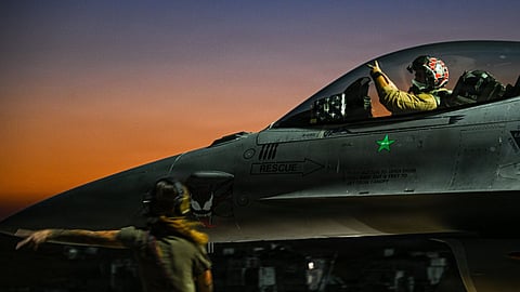 A US Air Force F-16 fighter jet undergoes pre-flight checks before take-off.