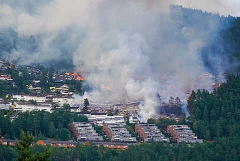 Smoke rises over terraced houses on fire in the Krokstadelva village in Drammen, Norway, Friday. July 17, 2026.
