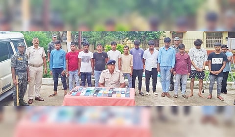 Puri police with the 13 accused and the mobile phones seized from them.