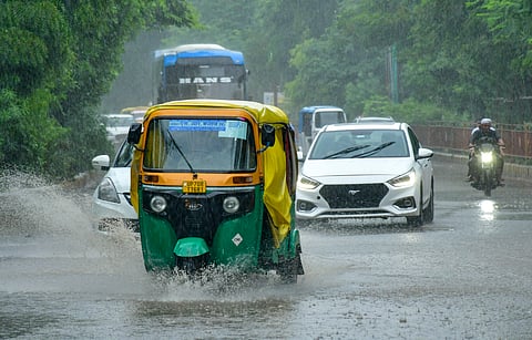 Vehicles ply on a rain-soaked road amid rainfall, in Prayagraj, Uttar Pradesh, Sunday, July 19, 2026. 