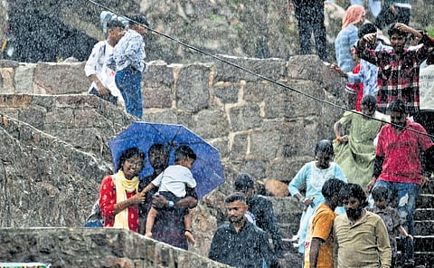 People enjoy	sudden drizzle  at Golconda Fort in Hyderabad on Sunday 