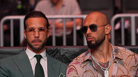 Andrew Tate, right, and his brother Tristan arrive an event, April 11, 2026, in Miami.