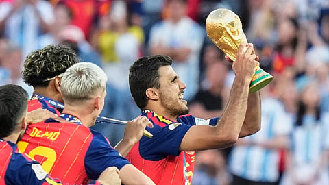 Spain’s Rodri (16) lifts the winners’ trophy after their win in the World Cup final soccer match against Argentina in East Rutherford, N.J., near New York, Sunday, July 19, 2026.