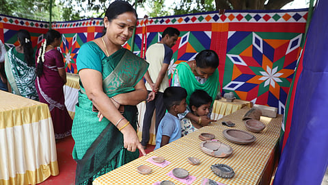 Visitors explore the unearthed items displayed at a stall set up at the excavation site at Vellalore in Coimbatore on Sunday.