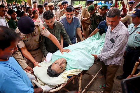 Officials carry the mortal remains of Tripura Director General of Police (DGP) Anurag Dhankar after he was found dead at his office, in Agartala, Monday, July 20, 2026.