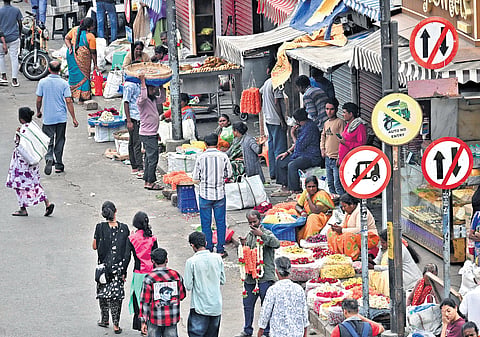 Even after the footpath on Avenue Road was cleared, street vendors have resumed their business, leaving no space for pedestrians on Monday 