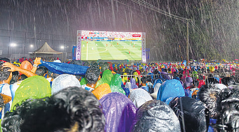 Undeterred by heavy rain, fans gather in large numbers to watch the World Cup final on a giant screen at Infopark, Kochi, in the early hours of Monday.
