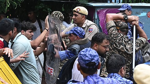 Security personnel cracking down on a crowd of protestors near Jantar Mantar during a protest march to Parliament in New Delhi on Monday, July 20
