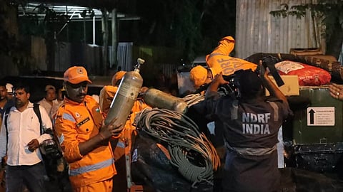  Rescue personnel conduct rescue operation after about 27 workers are trapped inside an under-construction tunnel after a landslide blocked its entrance and triggered a suspected gas leak, in Namchi district, Sikkim.