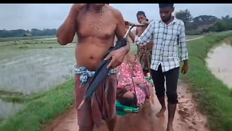 Screengrab of the woman being carried on cot 