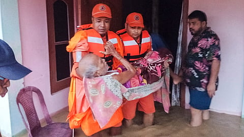 NDRF officials conduct a rescue operation in a flood-affected area, in Assam.