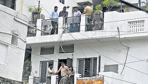Police personnel and forensic experts at the site of a fire in BK Dutt Colony | express