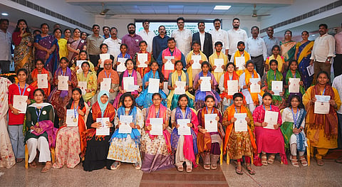 NTR District Collector G Lakshmisha and MLA Gadde Rammohan along with students in a felicitation programme.