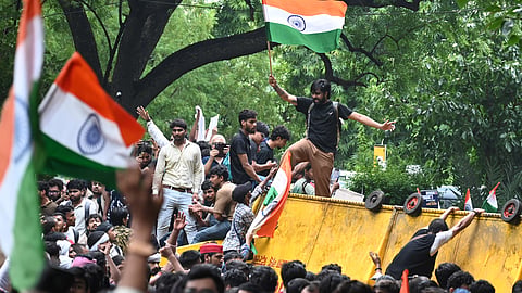 Cockroach Janata Party (CJP) supporters raise slogans as they gather ahead of a protest march, at the Jantar Mantar, in New Delhi, early Monday