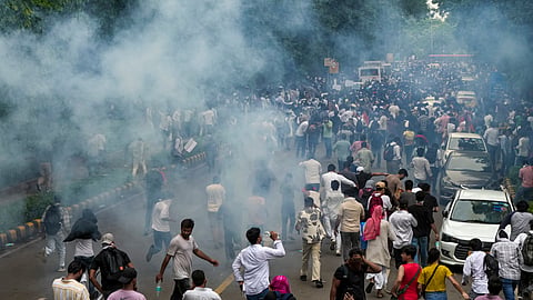 Security personnel fire tear gas shells to disperse Cockroach Janata Party (CJP) supporters during a protest march, near the Parliament in New Delhi, Monday, July 20, 2026.