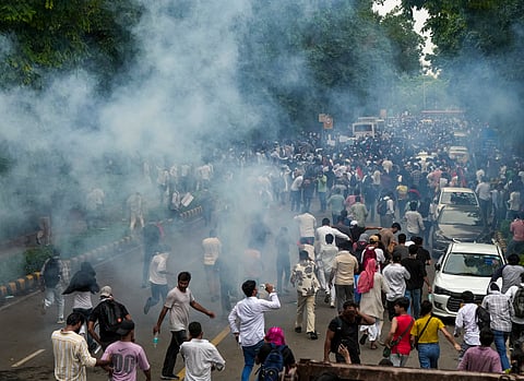: Security personnel fire tear gas shells to disperse Cockroach Janata Party (CJP) supporters during a protest march, near the Parliament in New Delhi, Monday, July 20, 2026