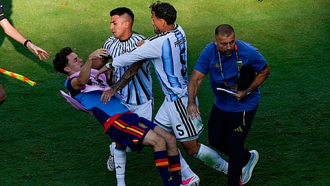 Spain's Gavi, left, falls as he scuffles with Argentina's Leandro Paredes (5) and Thiago Almada during the World Cup final soccer match between Spain and Argentina in East Rutherford, N.J., near New York, Sunday, July 19, 2026.