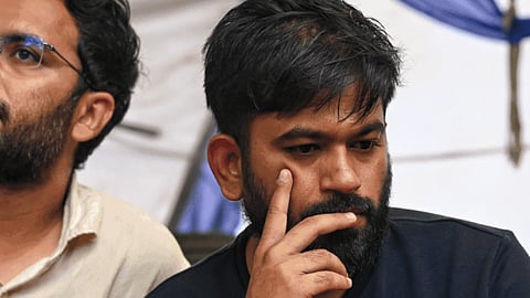 Cockroach Janata Party founder Abhijeet Dipke continues his sit-in protest demanding the resignation of Union Education Minister Dharmendra Pradhan over alleged irregularities in the NEET examination, in New Delhi, Tuesday, July 21, 2026