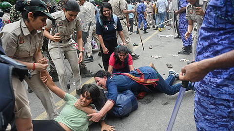 Police detain supporters of the Cockroach Janta Party as they attempt to march toward India's Parliament, demanding the resignation of the education minister, in New Delhi, Monday, July 20, 2026.
