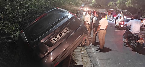  A car driven by a minor boy was left hanging precariously from a bridge on the Karur Bypass Road in Tiruchy after crashing into a steel crash barrier on Monday night. 