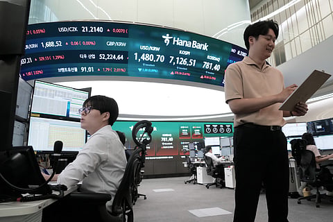 Currency traders work at the foreign exchange dealing room of the Hana Bank headquarters in Seoul, South Korea, Wednesday, July 22, 2026.