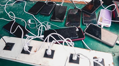 Phones are kept for charging at a Doctors Without Borders informal camp in Mardyck, northern France, Wednesday, July 2, 2025